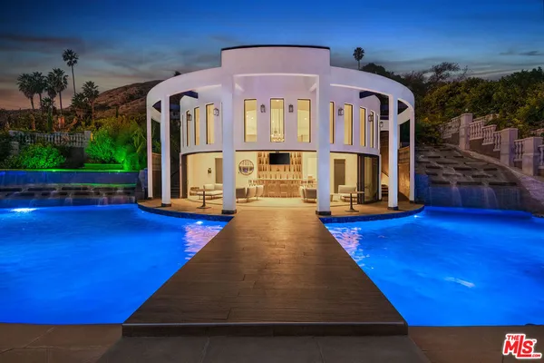 a front view of a house with swimming pool