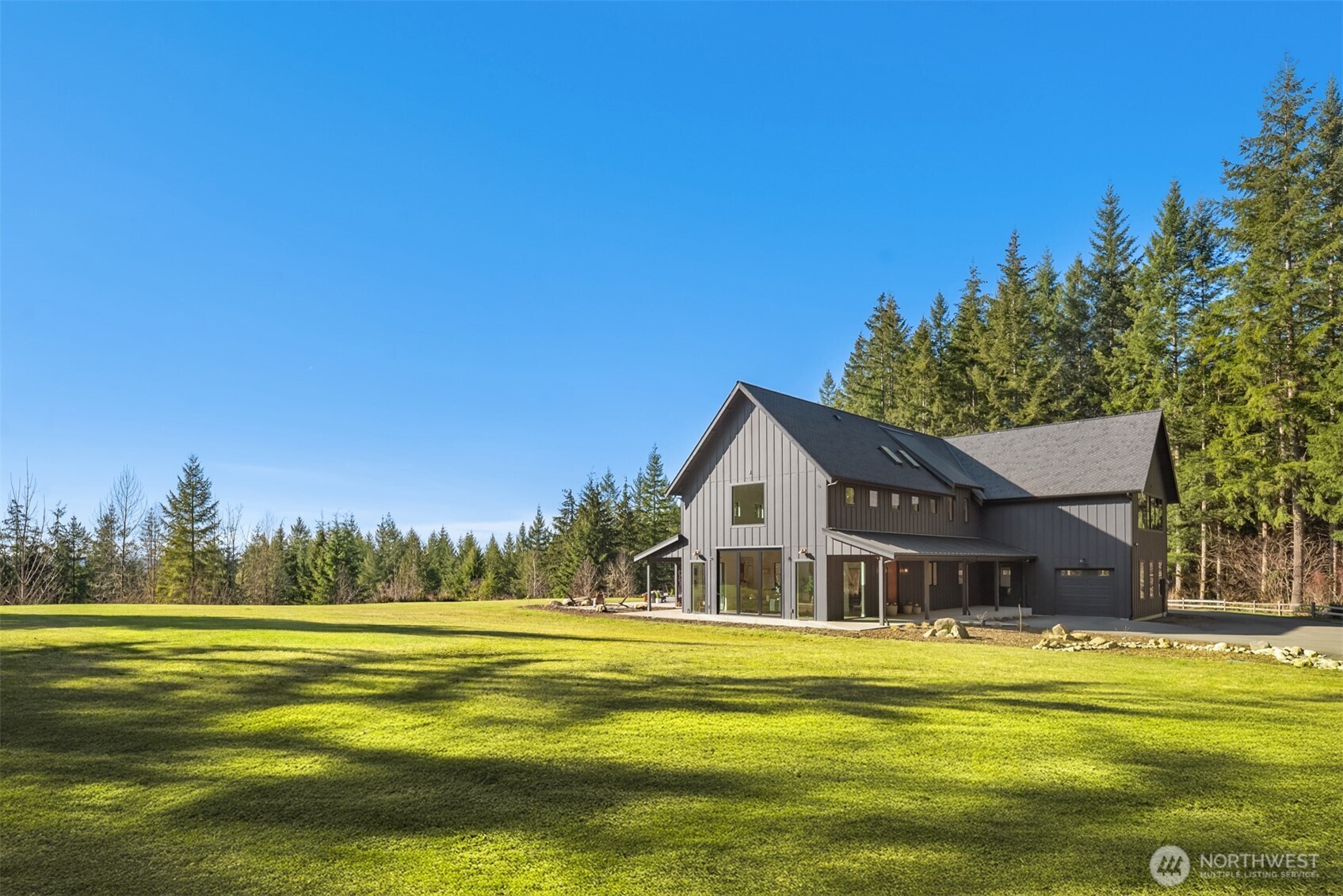 a front view of house with yard and lake view