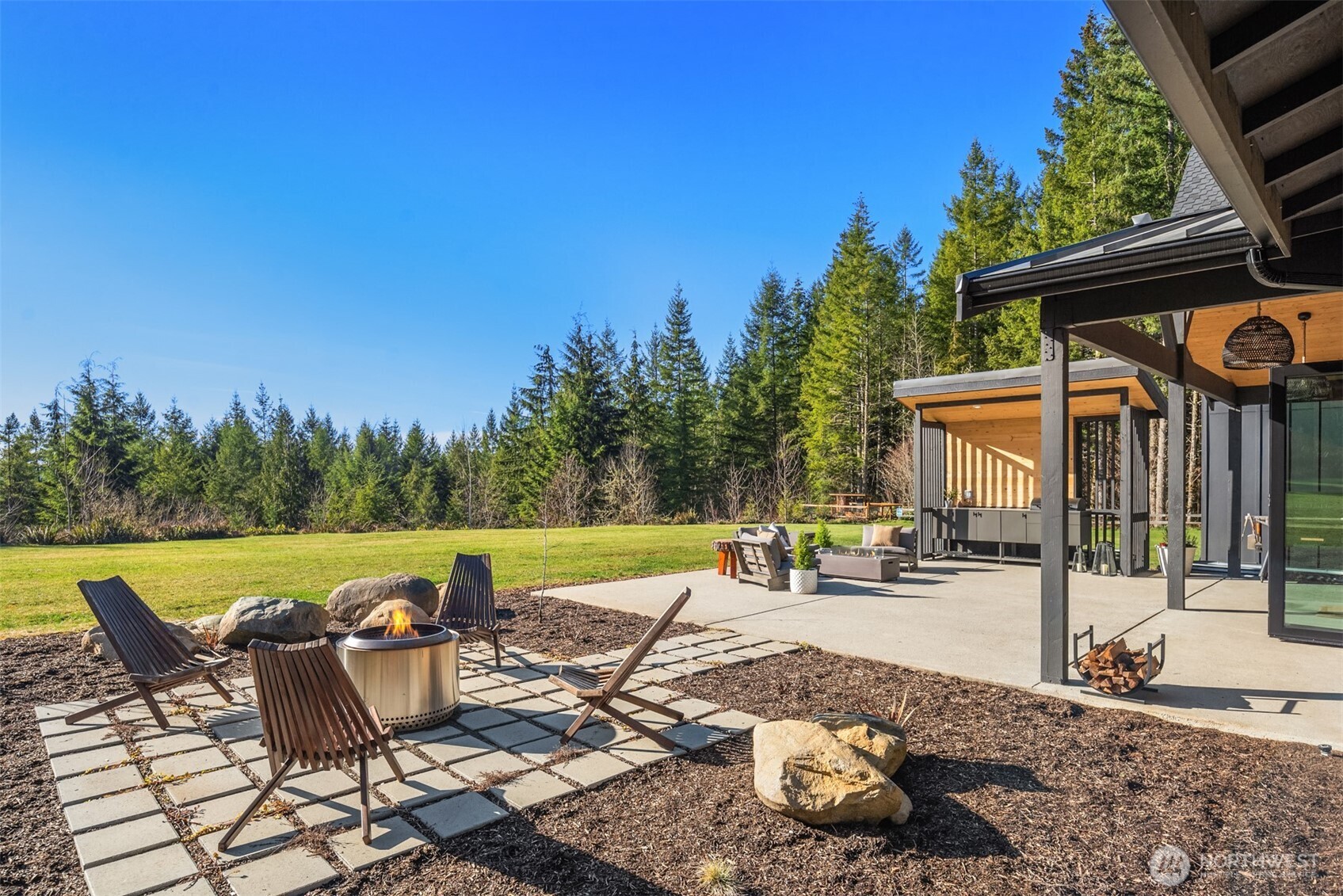 33310 Northeast 95th Place Carnation, WA 98014 - Photo 31 of 40 a view of a patio with a table and chairs under an umbrella