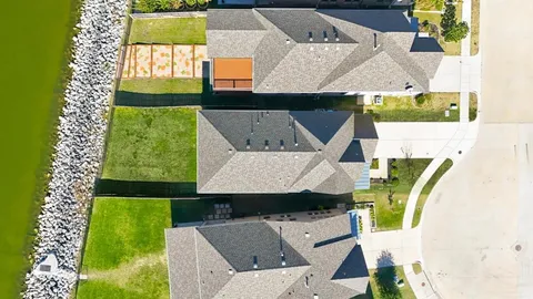 an aerial view of a house with a swimming pool