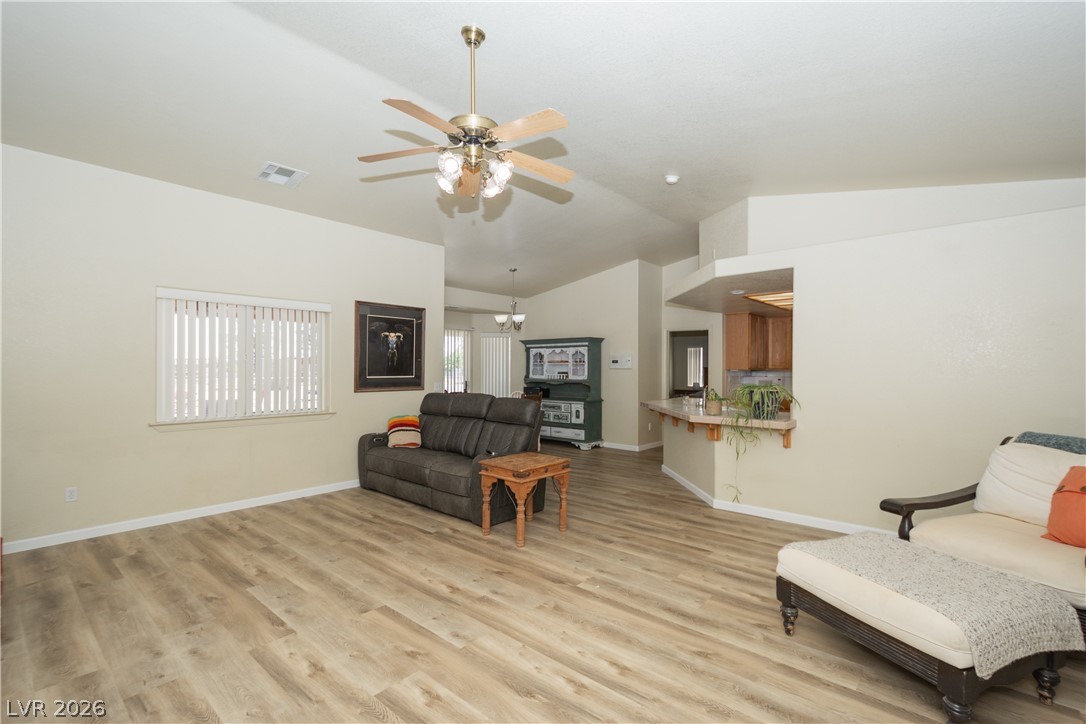 2381 Tough Boy Road Pahrump, NV 89060 - Photo 5 of 44 This living area features a warm atmosphere with wood flooring and recessed lighting.