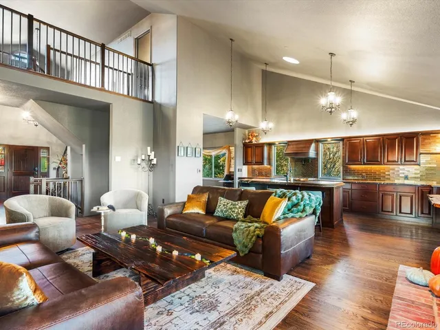 a living room with furniture and a floor to ceiling window