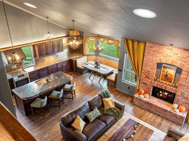 a kitchen with a table chairs stove and wooden floor