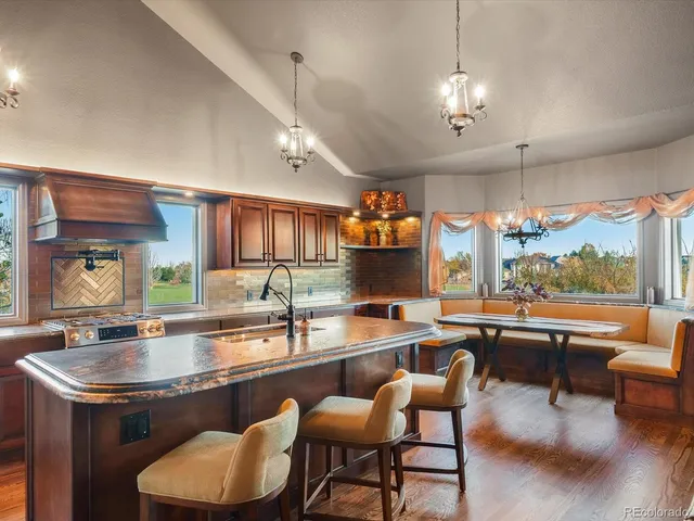 a view of a kitchen with a table and a chair