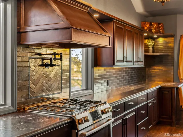 a living room with furniture large window and wooden floor