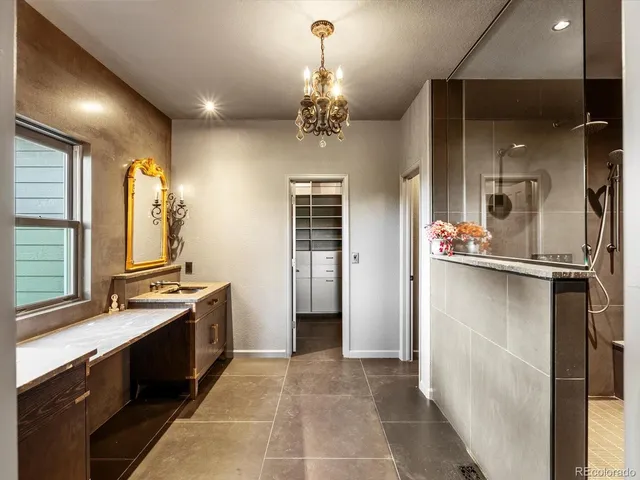 a bathroom with a granite countertop sink a toilet and shower
