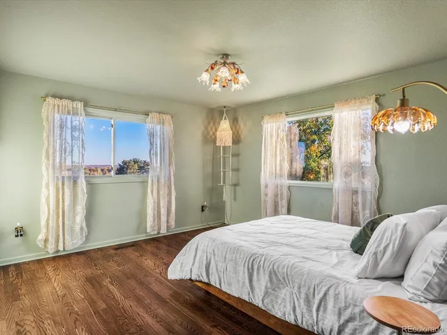 a bathroom with a granite countertop sink a toilet a mirror and shower