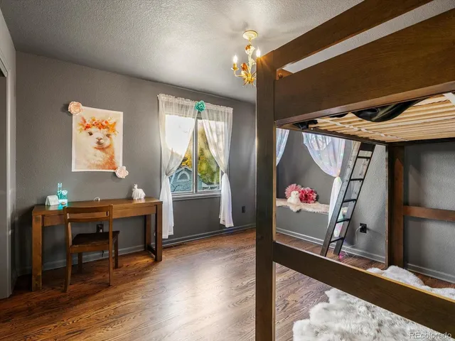 a view of a livingroom with wooden floor and a window