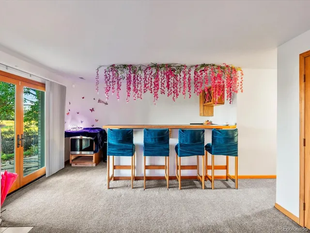 a room with pool table and a chandelier