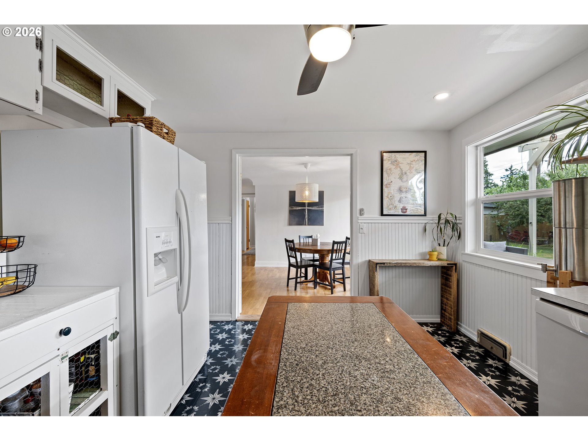 765 Louis Street Eugene, OR 97402 - Photo 12 of 45 a kitchen with stainless steel appliances kitchen island granite countertop a refrigerator and a sink