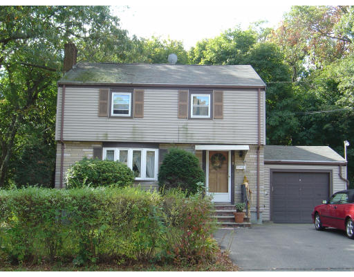 a house that has a tree in front of it