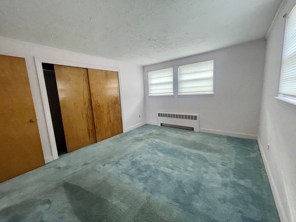 31 Bear Hill Road Stoneham, MA 02180 - Photo 12 of 30 a view of room with window and a wooden floor