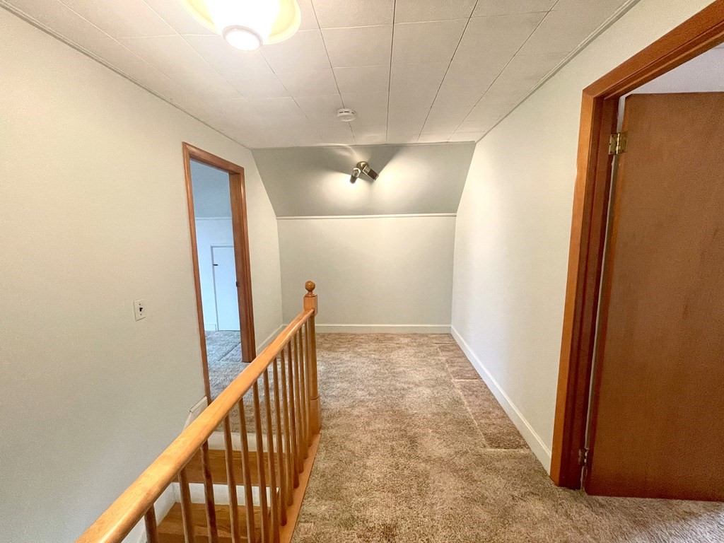 31 Bear Hill Road Stoneham, MA 02180 - Photo 16 of 30 a view of a hallway with wooden floor and stairs