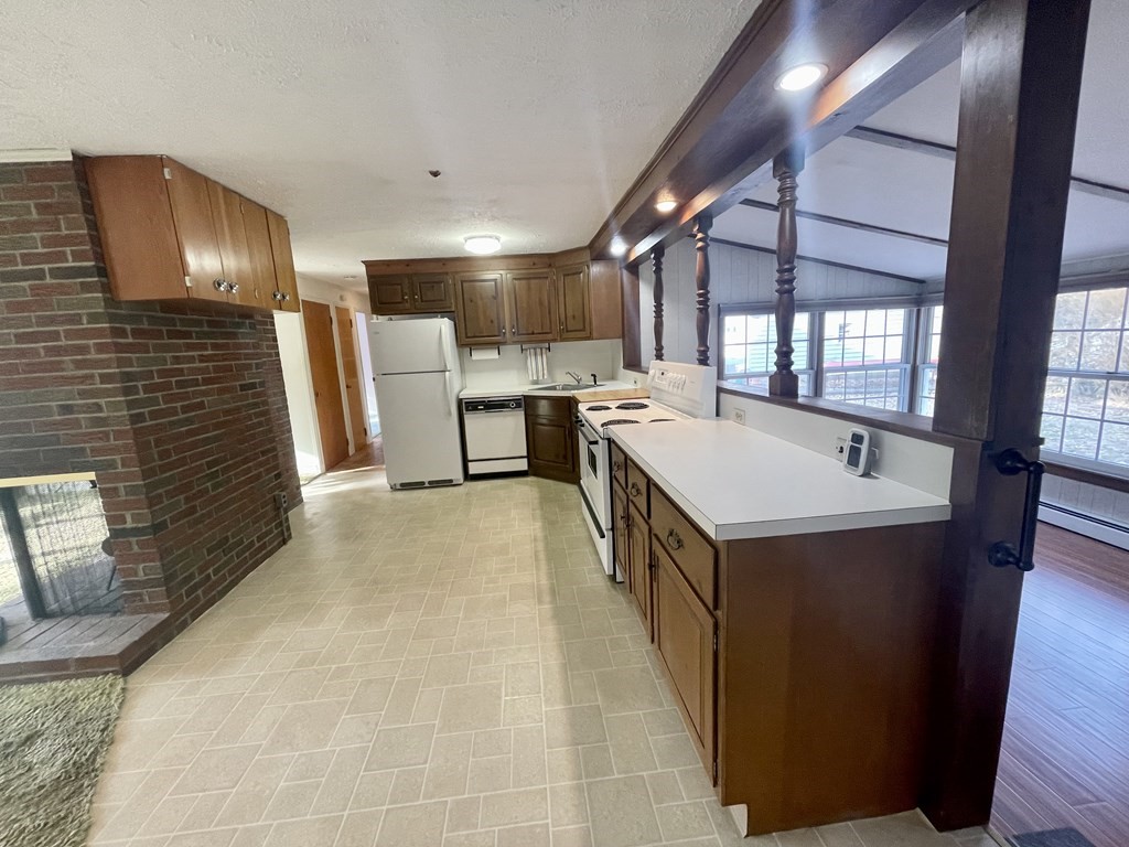 31 Bear Hill Road Stoneham, MA 02180 - Photo 6 of 30 a large white kitchen with a sink a refrigerator and window