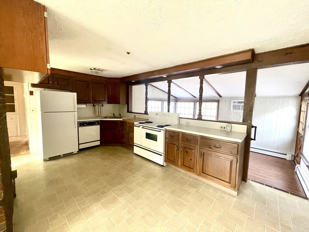 31 Bear Hill Road Stoneham, MA 02180 - Photo 8 of 30 a kitchen with a refrigerator a stove top oven and a large window