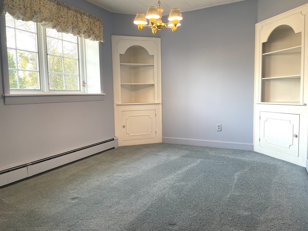 31 Bear Hill Road Stoneham, MA 02180 - Photo 9 of 30 an empty room with windows and chandelier
