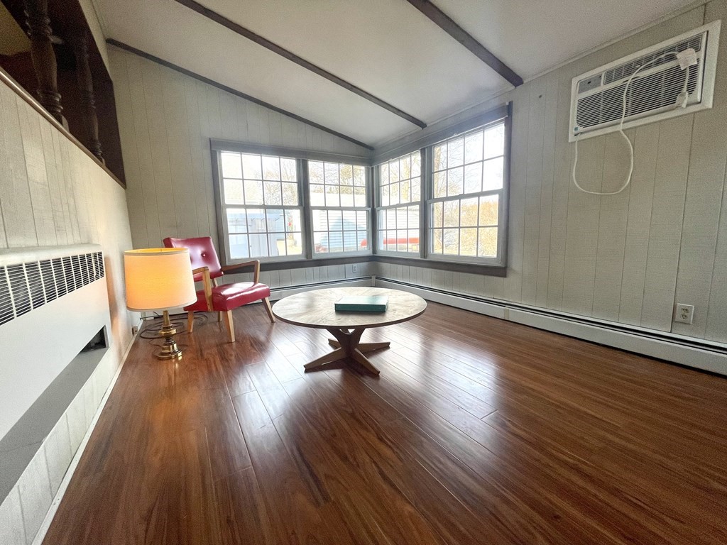 31 Bear Hill Road Stoneham, MA 02180 - Photo 10 of 30 a living room with furniture a table and wooden floor