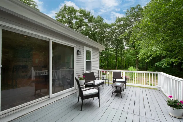 a view of balcony with furniture and wooden deck