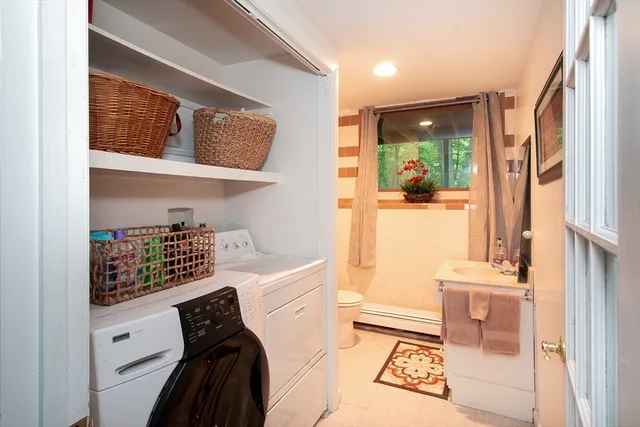 a room with a baby crib furniture and a window
