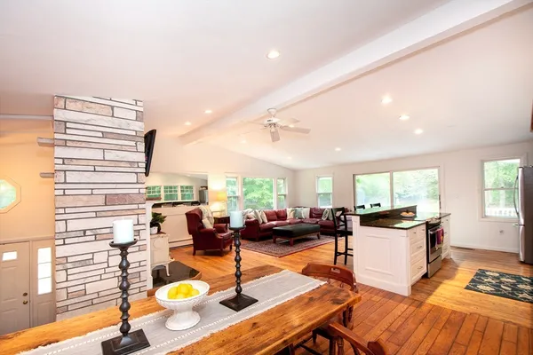 a living room with furniture and a kitchen view