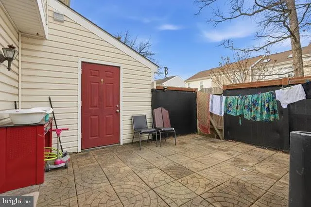 a view of a chair and tables in the patio