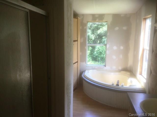2033 Brer Rabbit Run Rock Hill, SC 29730 - Photo 8 of 13 a bath tub sitting in a bathroom next to a window
