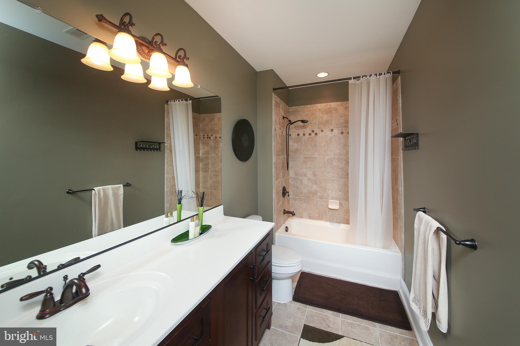 342 Alexander Drive Telford, PA 18969 - Photo 27 of 31 a bathroom with a sink a tub and a mirror
