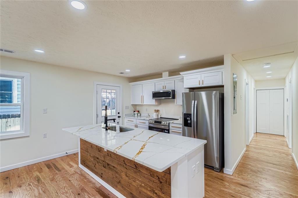 194 Dearborn Street Southeast Atlanta, GA 30317 - Photo 11 of 25 a kitchen with stainless steel appliances a refrigerator and a sink