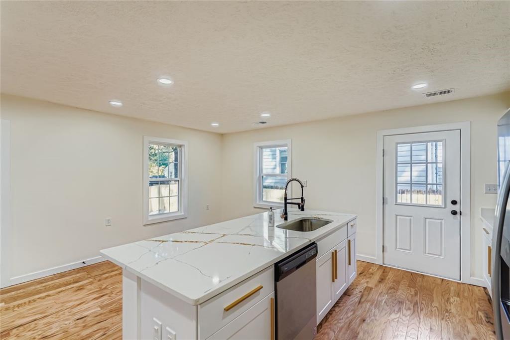 194 Dearborn Street Southeast Atlanta, GA 30317 - Photo 12 of 25 a kitchen with a sink stove and cabinets