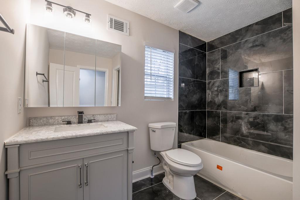 2248 Willoby Court Morrow, GA 30260 - Photo 13 of 31 a bathroom with a sink a toilet and shower