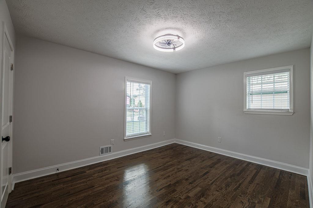 2248 Willoby Court Morrow, GA 30260 - Photo 16 of 31 an empty room with wooden floor and windows