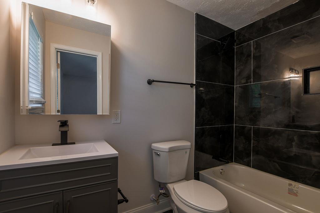 2248 Willoby Court Morrow, GA 30260 - Photo 17 of 31 a bathroom with a sink toilet and shower