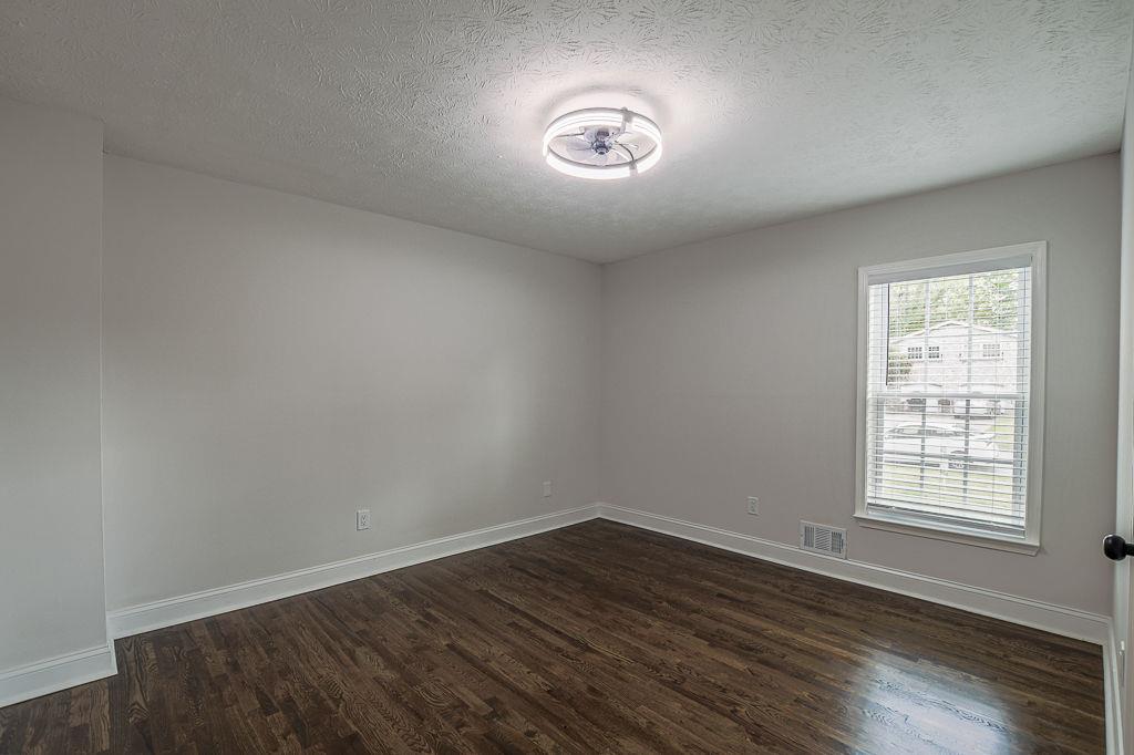 2248 Willoby Court Morrow, GA 30260 - Photo 23 of 31 an empty room with wooden floor and windows