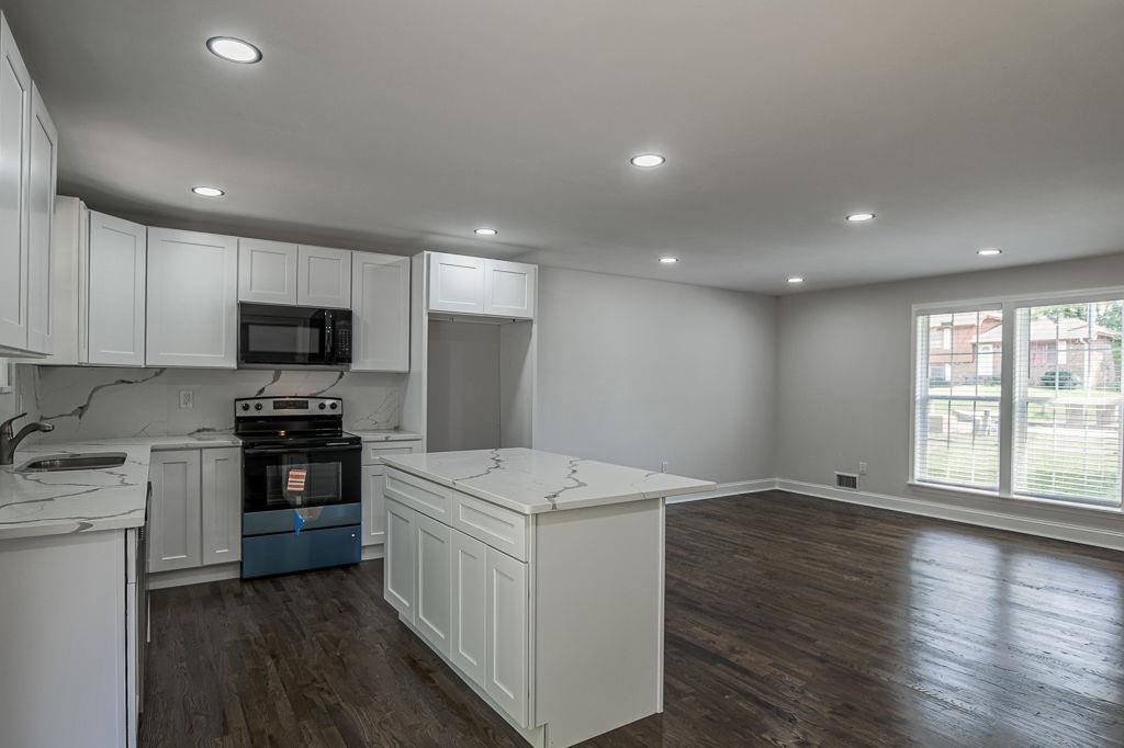 2248 Willoby Court Morrow, GA 30260 - Photo 5 of 31 a kitchen with stainless steel appliances granite countertop a stove a sink and a refrigerator