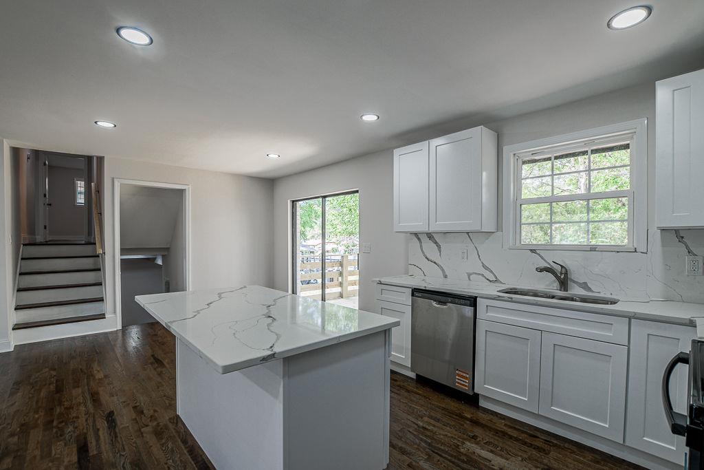 2248 Willoby Court Morrow, GA 30260 - Photo 6 of 31 a kitchen with stainless steel appliances a sink stove and cabinets