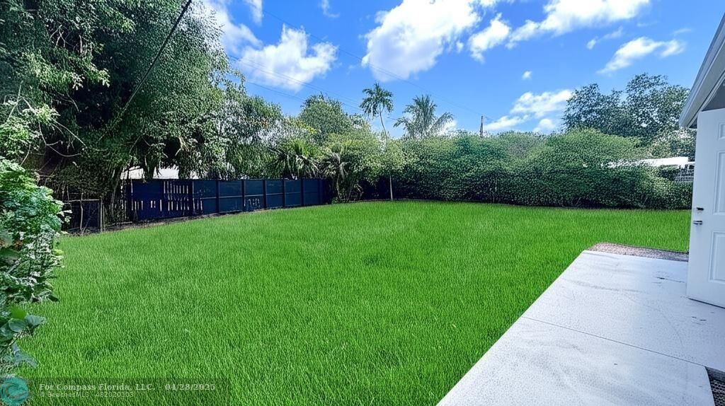 5737 Greene Street Hollywood, FL 33021 - Photo 11 of 13 a view of a yard with grass and a fountain