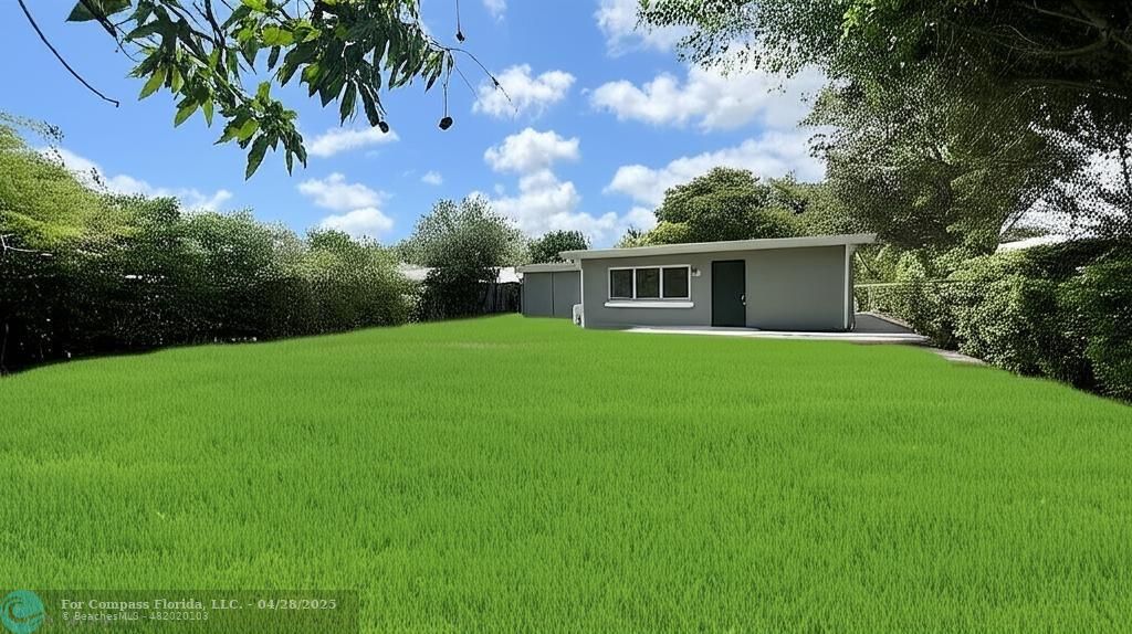 5737 Greene Street Hollywood, FL 33021 - Photo 12 of 13 a front view of a house with yard and green space