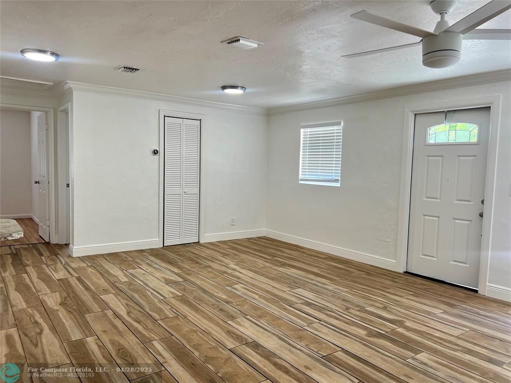 5737 Greene Street Hollywood, FL 33021 - Photo 3 of 13 wooden floor in an empty room with a window