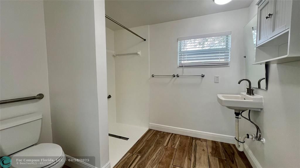 5737 Greene Street Hollywood, FL 33021 - Photo 6 of 13 a bathroom with a sink toilet and a mirror