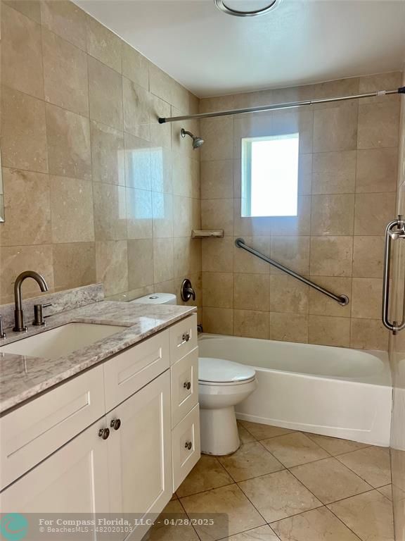 5737 Greene Street Hollywood, FL 33021 - Photo 10 of 13 a bathroom with a granite countertop sink a toilet and bathtub