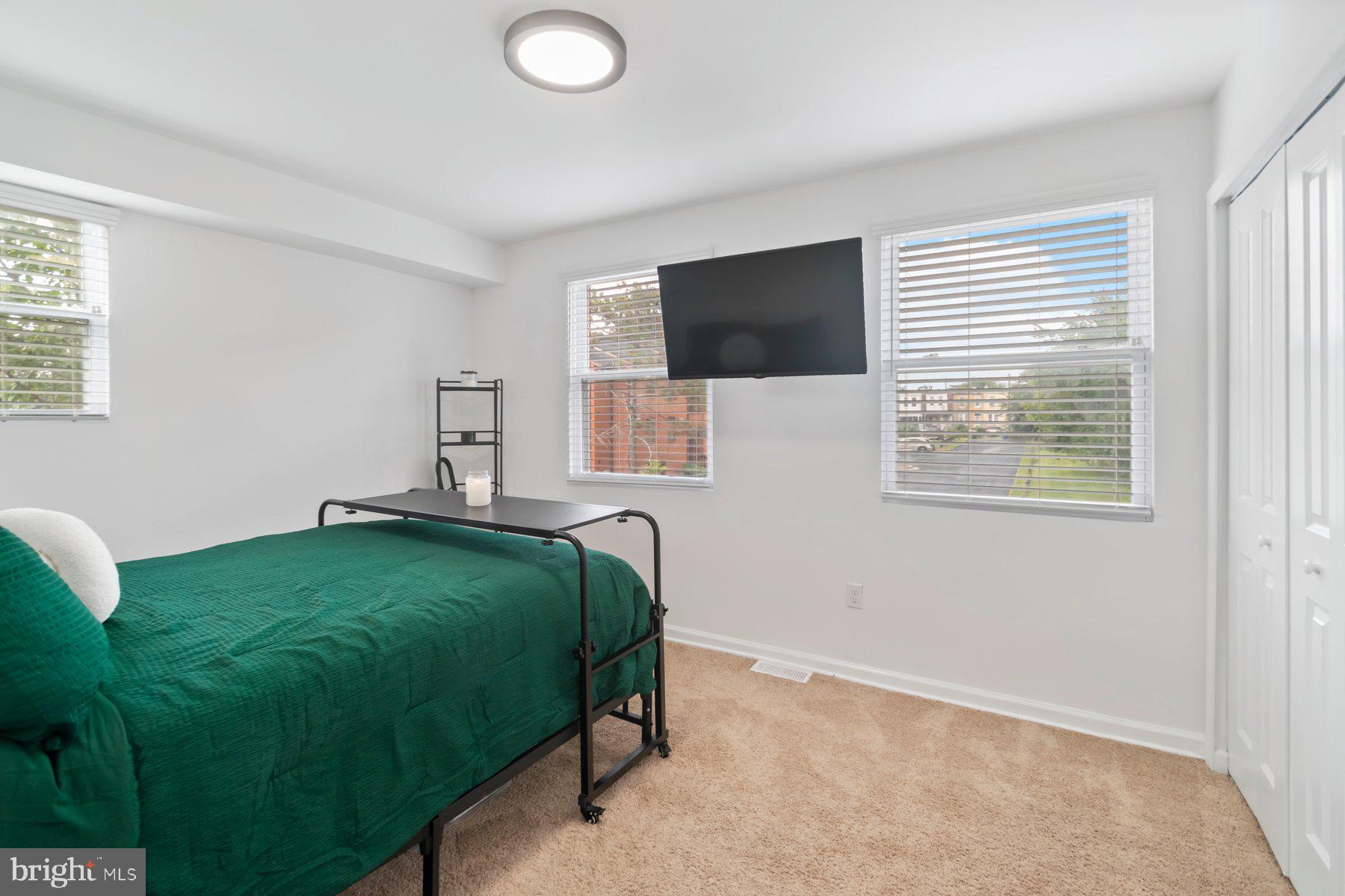 1221 East Oliver Street Baltimore, MD 21202 - Photo 11 of 26 a bedroom with a bed and a television