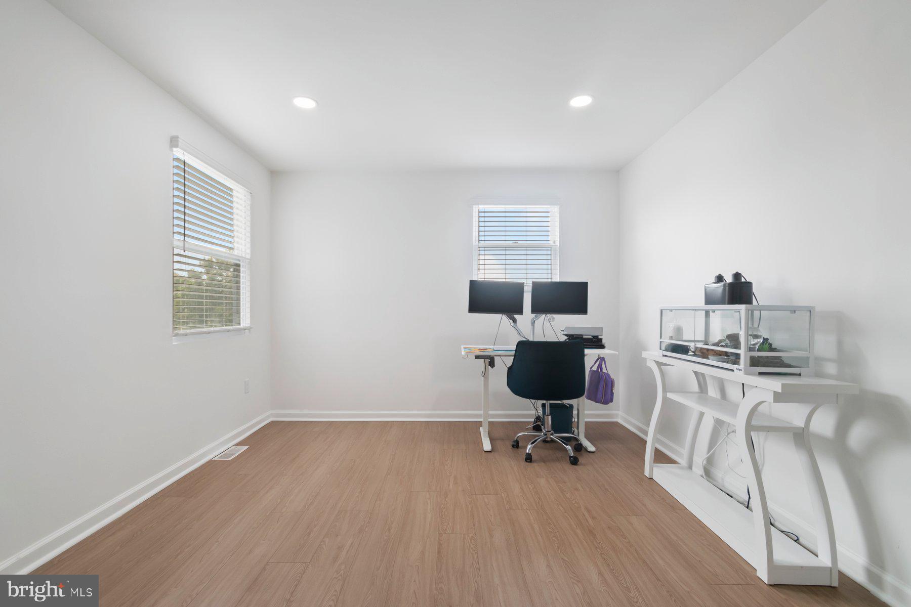 1221 East Oliver Street Baltimore, MD 21202 - Photo 13 of 26 a view of a workspace with furniture and a window