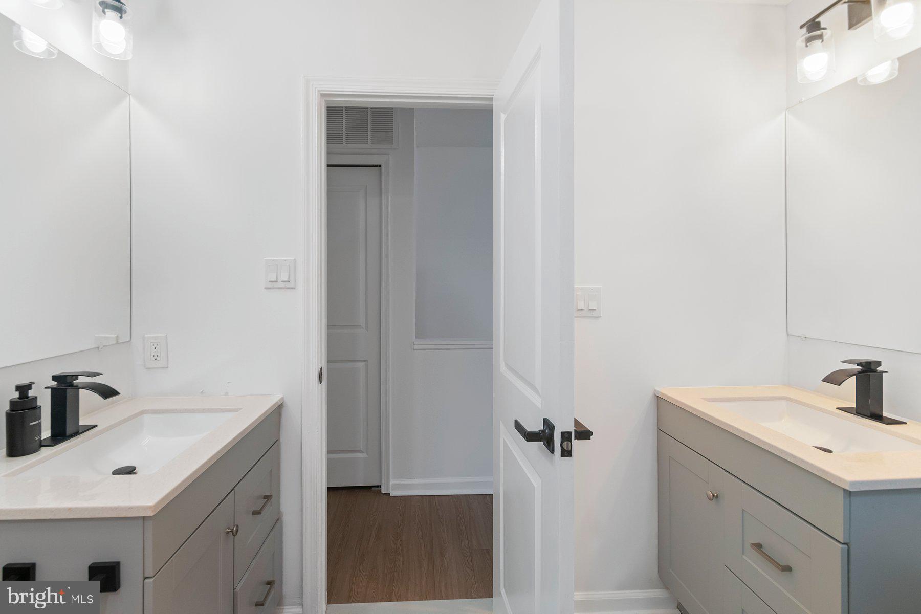 1221 East Oliver Street Baltimore, MD 21202 - Photo 17 of 26 a bathroom with a sink and mirror