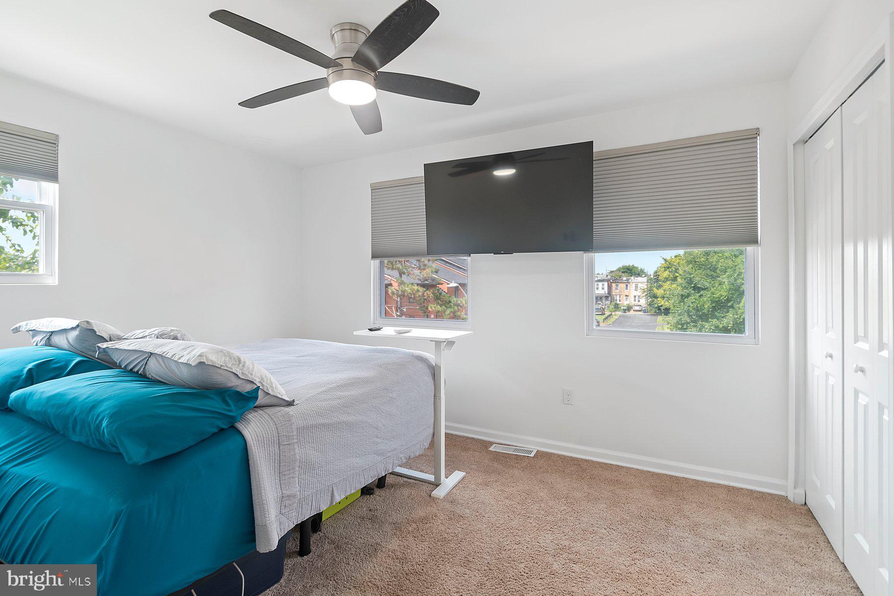 1221 East Oliver Street Baltimore, MD 21202 - Photo 19 of 26 a bedroom with a bed and a flat screen tv