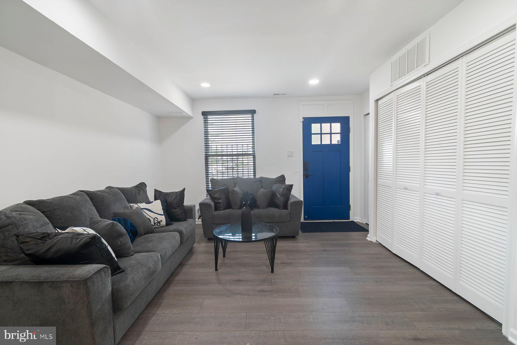 1221 East Oliver Street Baltimore, MD 21202 - Photo 2 of 26 a living room with furniture and a window