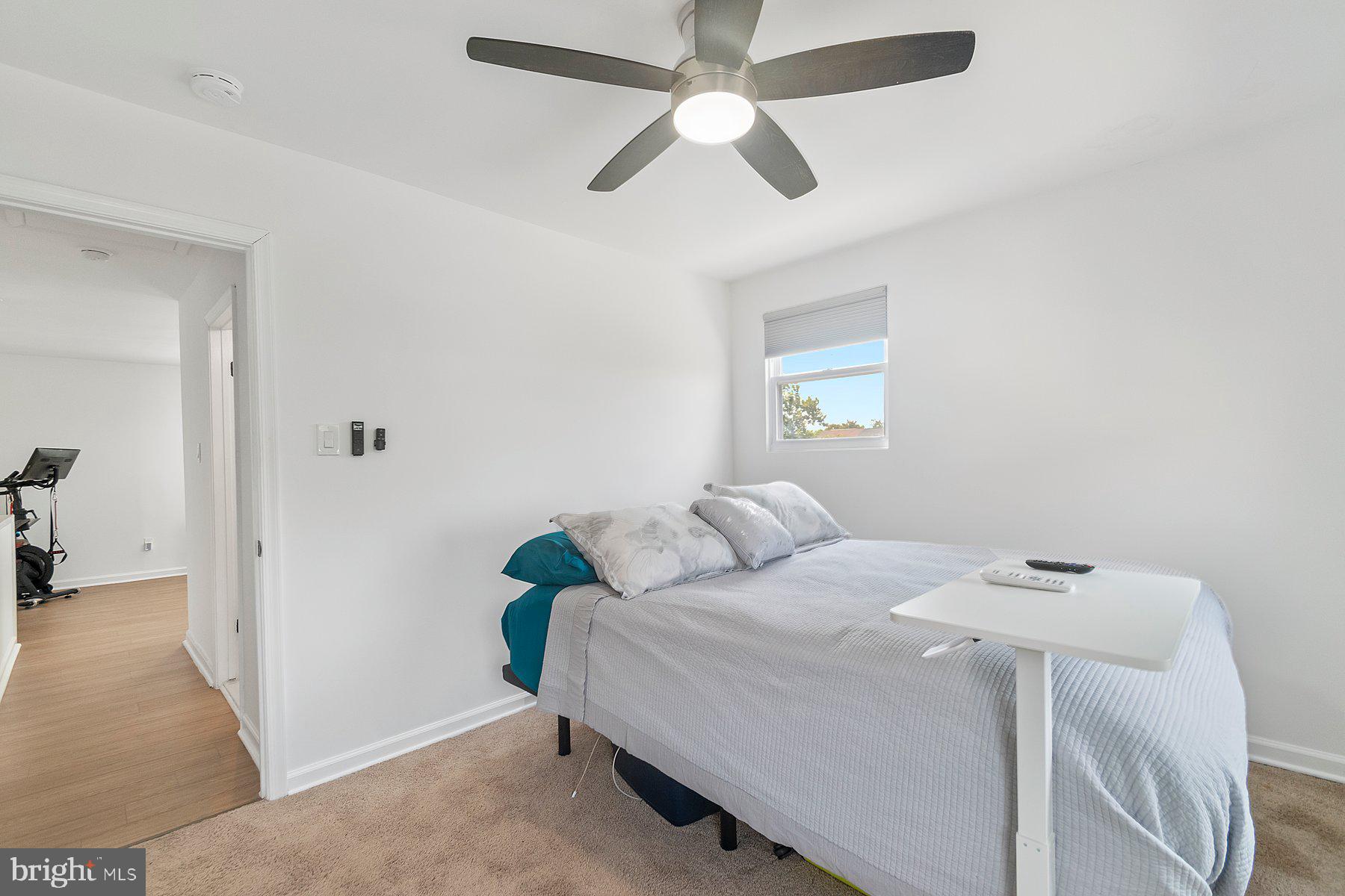 1221 East Oliver Street Baltimore, MD 21202 - Photo 20 of 26 a bedroom with a bed and a ceiling fan