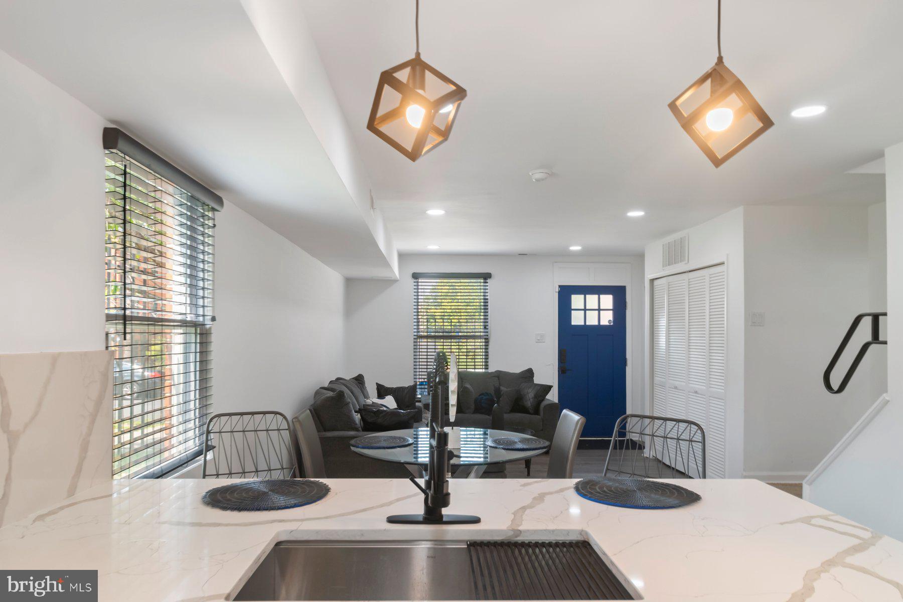 1221 East Oliver Street Baltimore, MD 21202 - Photo 5 of 26 a kitchen with living room and couch