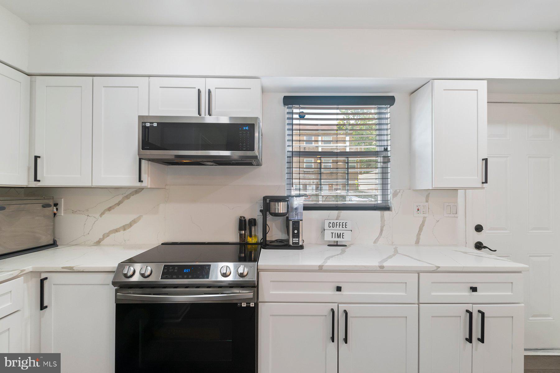 1221 East Oliver Street Baltimore, MD 21202 - Photo 8 of 26 a kitchen with a sink and cabinets