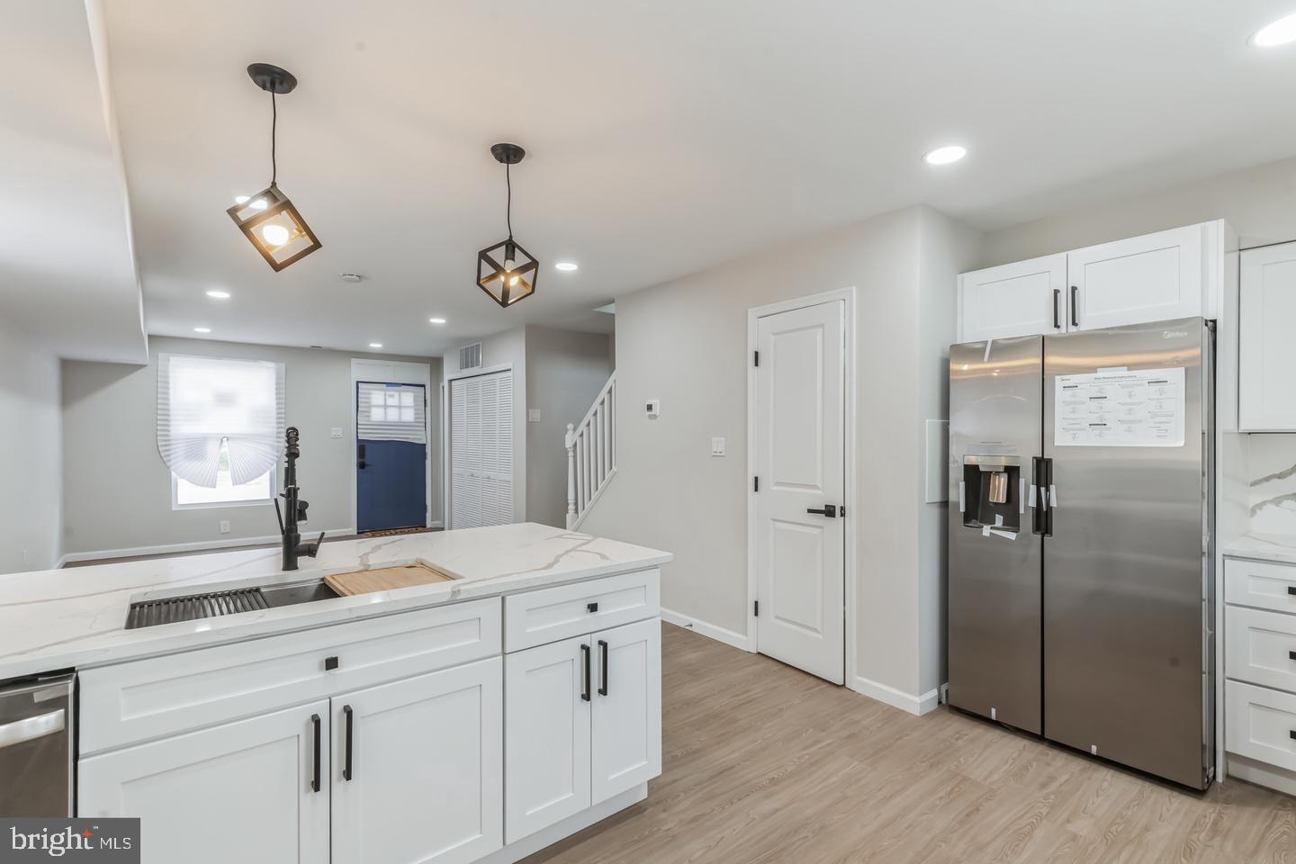1221 East Oliver Street Baltimore, MD 21202 - Photo 26 of 26 a bathroom with a double vanity sink mirror and shower