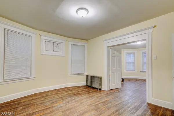 wooden floor in a hall with an empty room